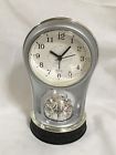 731015248599 Unbranded Silver Quartz Alarm Clock With Rotating Scene