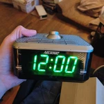 Projection Dual Alarm Clock Radio, Black And Silver With Green Led Display. Fixed Price $29.00.