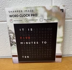 Sharper Image Word Clock Pro, Dimmable, Red 5 Alert, Wall Mount, Desk Stand, New. Fixed Price $20.00.