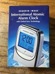 Sharper Image International Atomic Travel Clock World Timekeep CH001. Fixed Price $34.95.