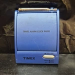 The Timex Flip Top Travel Alarm Clock Am/fm Portable Radio Model T315L. Fixed Price $19.99.