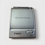The Timex Flip Top Travel Alarm Clock Am/fm Portable Radio Model T315S. Fixed Price $22.99.