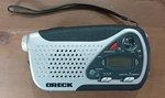 Oreck - Take Along Weather Emergency Hand Crank & Battery Radio Flashlight. Fixed Price $14.00.